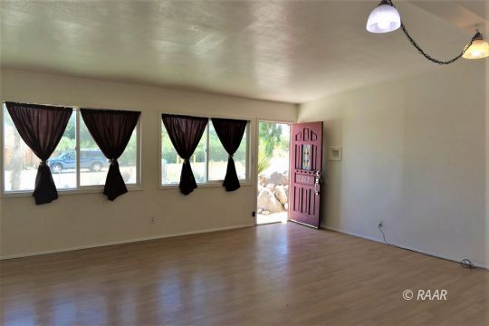 1263 Primrose Street Ridgecrest, CA 93555 - Photo 3 of 35 a view of an empty room with windows