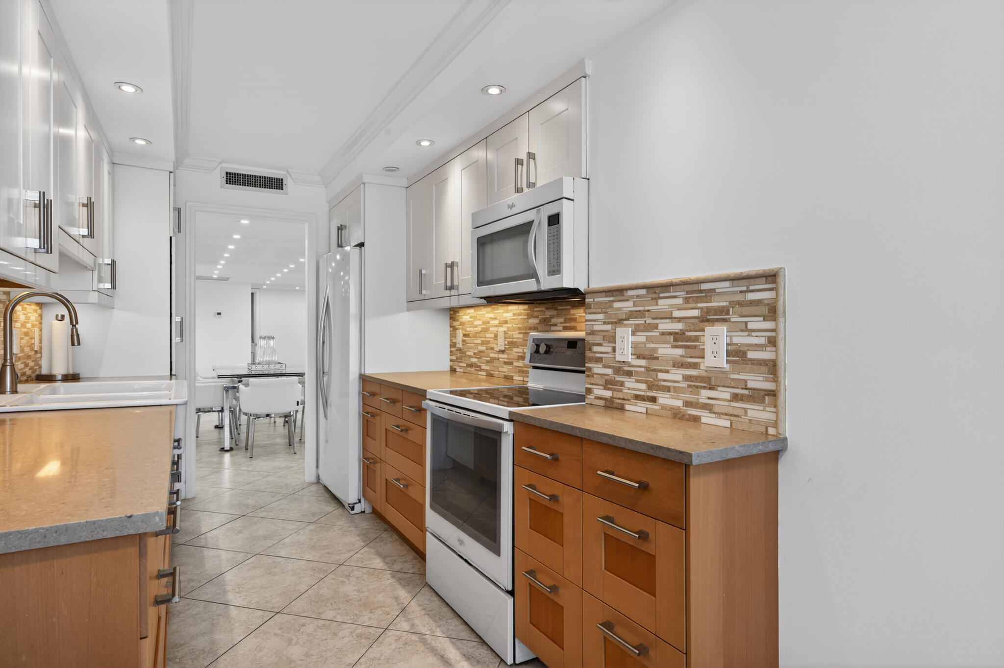4200 North Ocean Avenue, Unit 11101 Riviera Beach, FL 33404 - Photo 16 of 35 a kitchen with stainless steel appliances granite countertop a stove and a sink