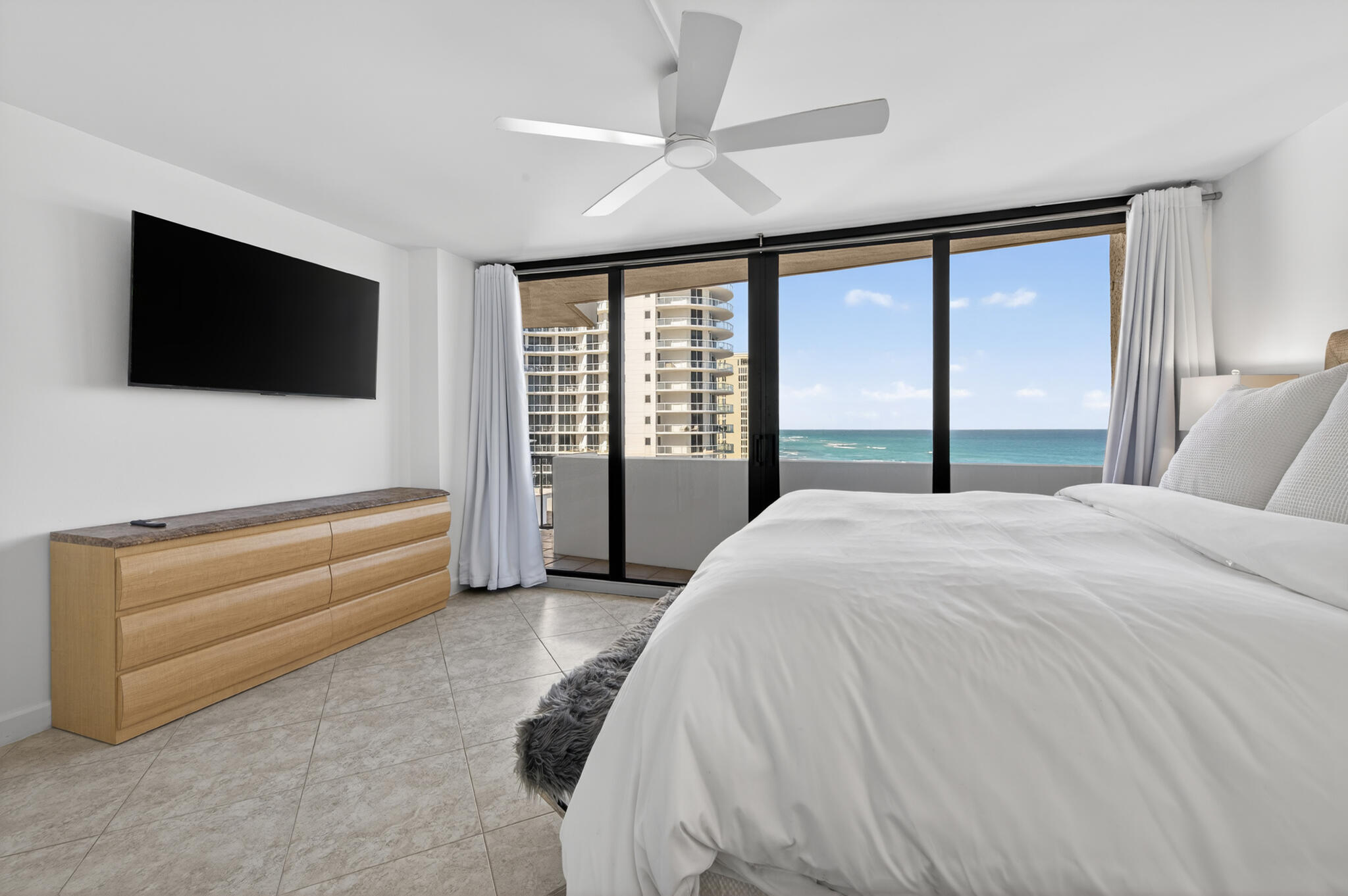 4200 North Ocean Avenue, Unit 11101 Riviera Beach, FL 33404 - Photo 19 of 35 a bedroom with a bed and a flat screen tv