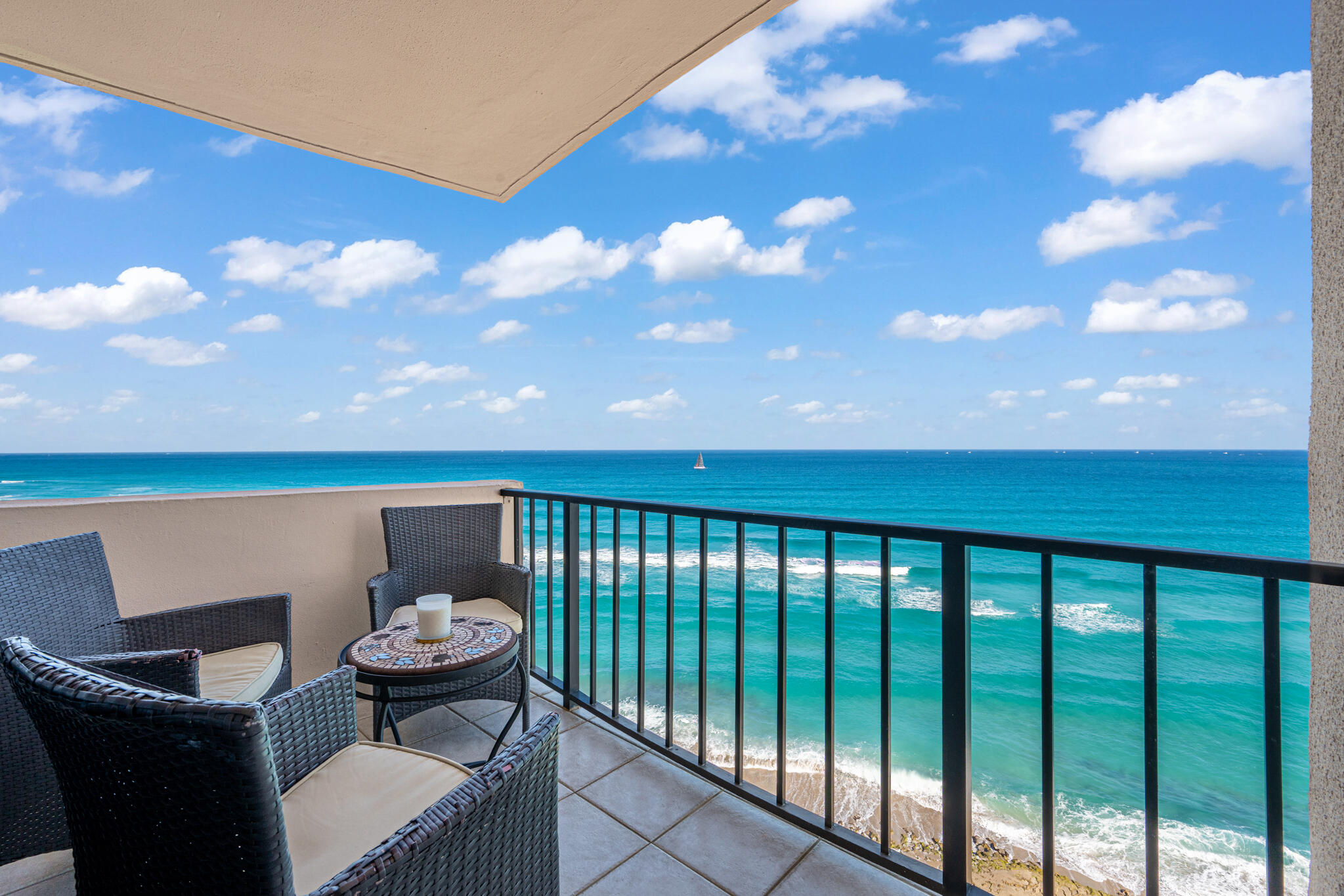 4200 North Ocean Avenue, Unit 11101 Riviera Beach, FL 33404 - Photo 2 of 35 a balcony with table and chairs