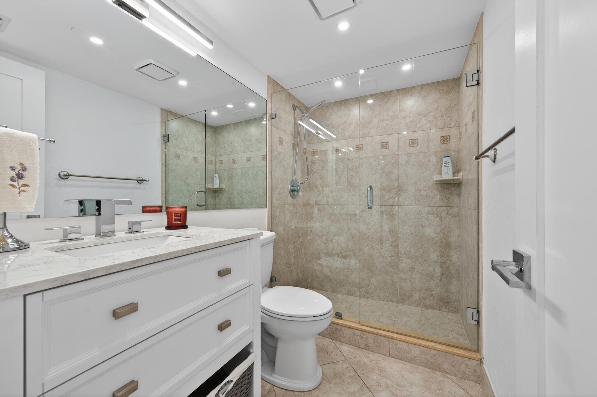 4200 North Ocean Avenue, Unit 11101 Riviera Beach, FL 33404 - Photo 24 of 35 a bathroom with a double vanity sink toilet and shower