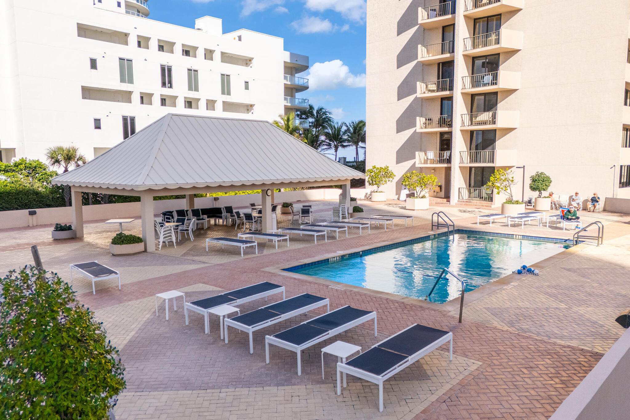 4200 North Ocean Avenue, Unit 11101 Riviera Beach, FL 33404 - Photo 30 of 35 a view of pool with outdoor seating and buildings in the background
