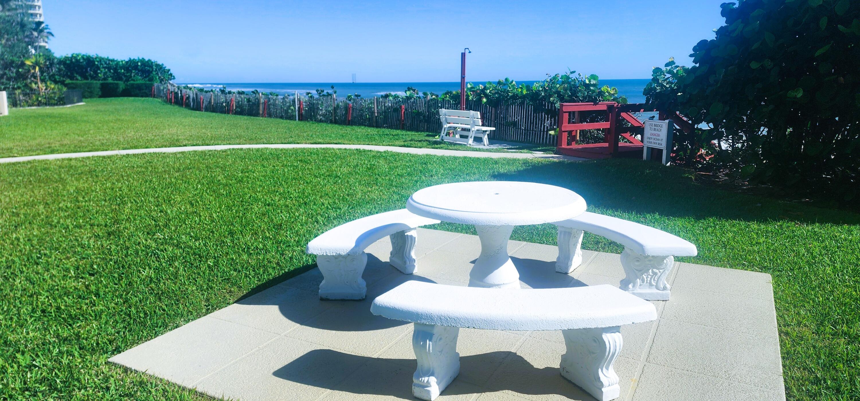 4200 North Ocean Avenue, Unit 11101 Riviera Beach, FL 33404 - Photo 35 of 35 a view of a chairs and table in backyard of the house