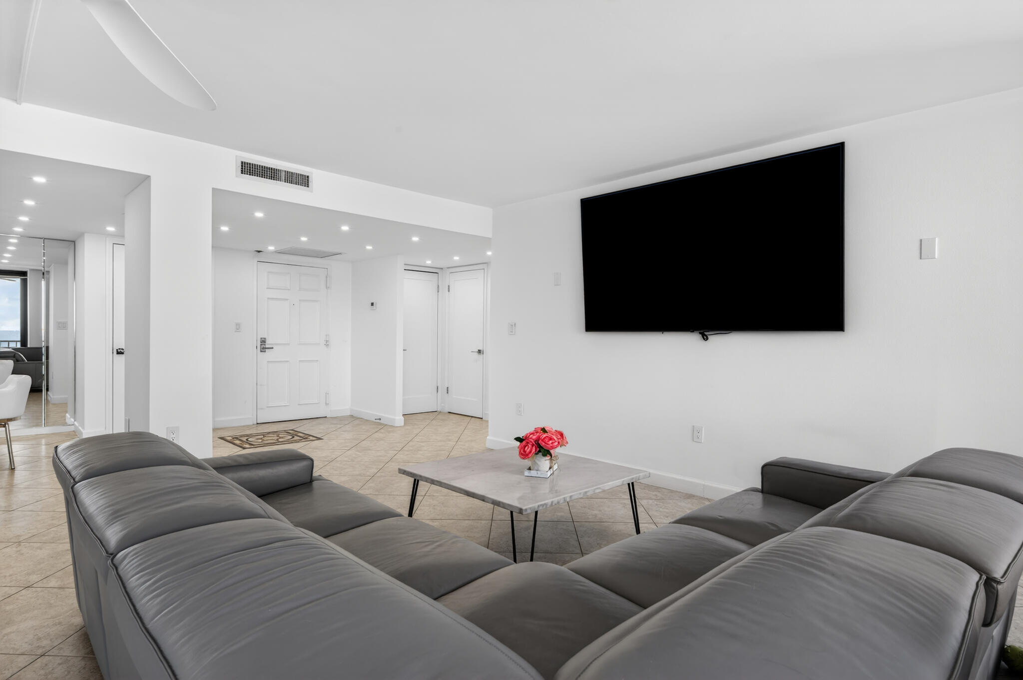 4200 North Ocean Avenue, Unit 11101 Riviera Beach, FL 33404 - Photo 10 of 35 a living room with furniture and a flat screen tv
