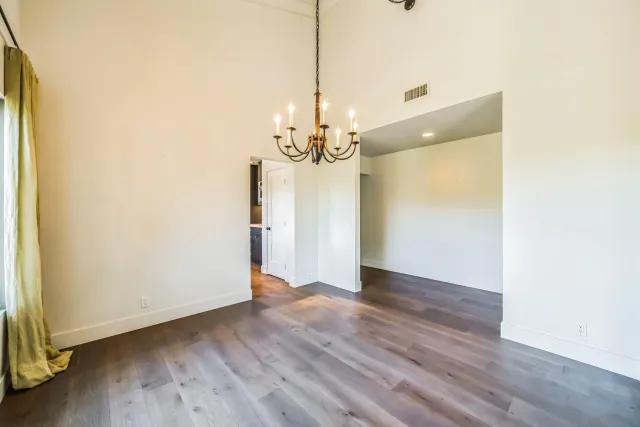 a view of a room with wooden floor