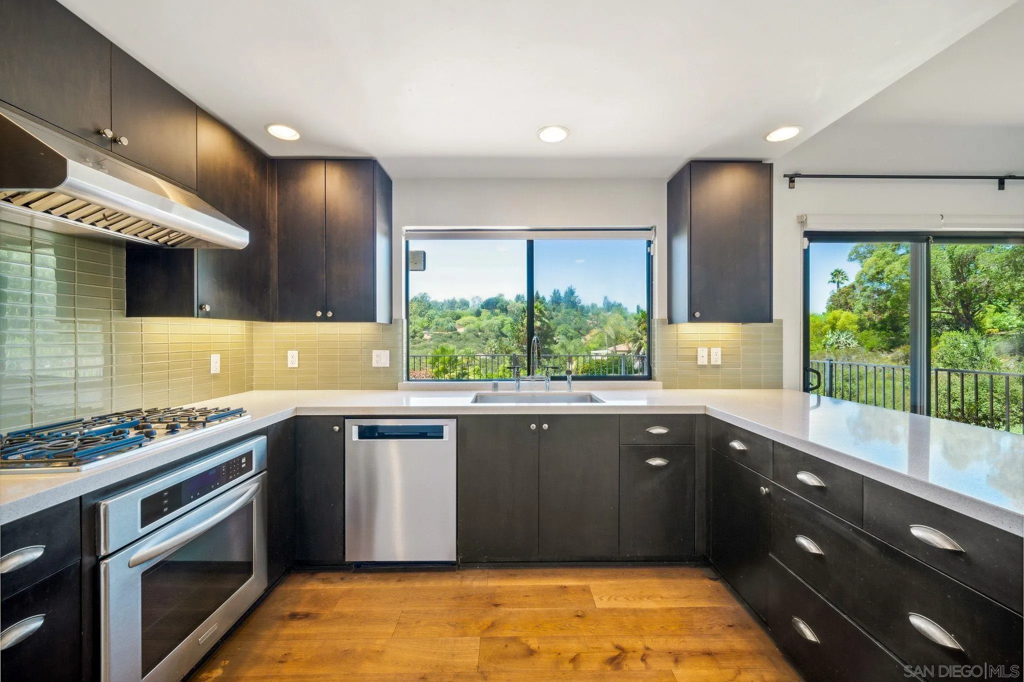 17335 Via Del Bravo Rancho Santa Fe, CA 92067 - Photo 15 of 47 a kitchen with stainless steel appliances granite countertop a sink and stove