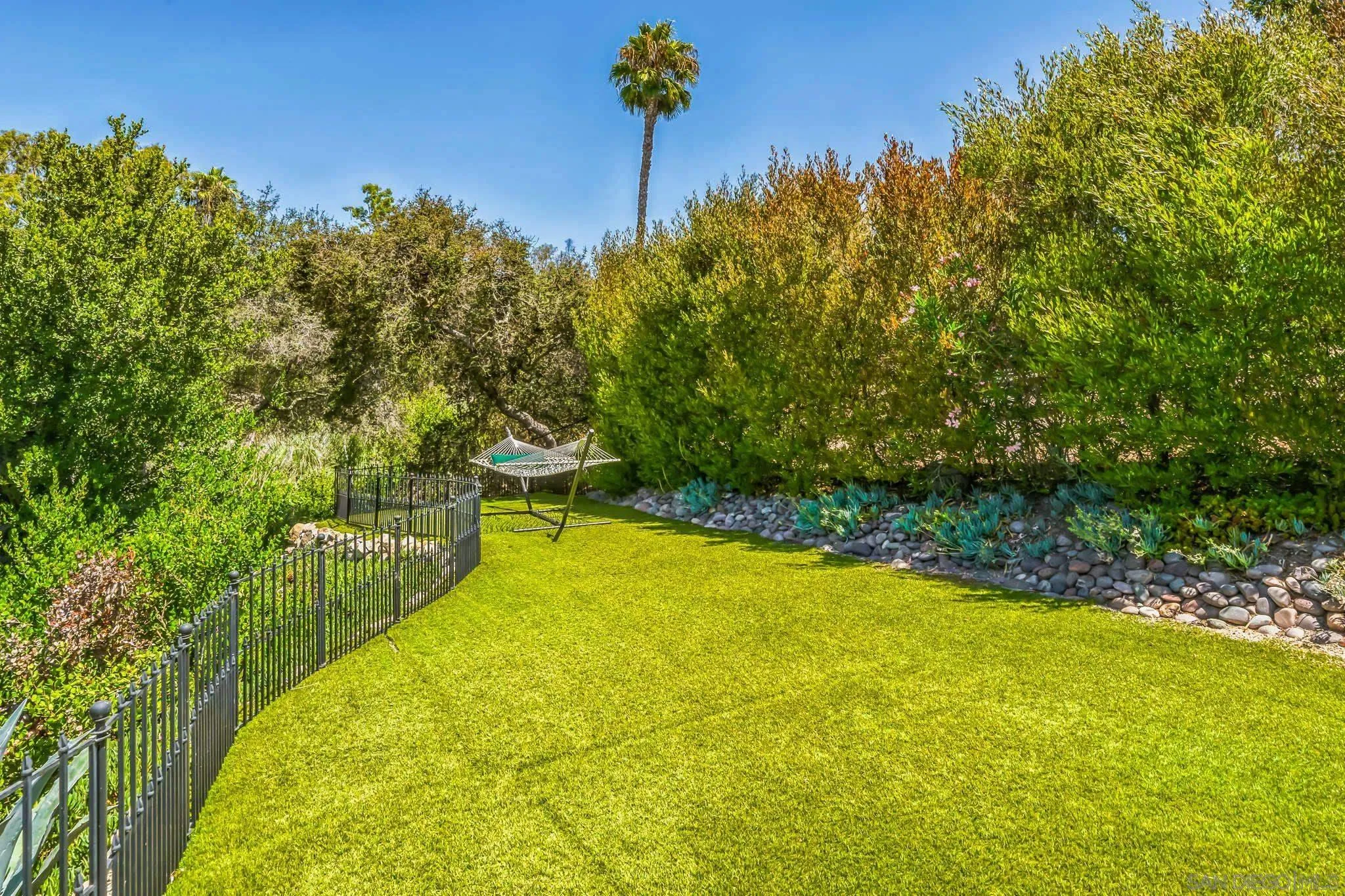 17335 Via Del Bravo Rancho Santa Fe, CA 92067 - Photo 41 of 47 a view of a swimming pool with an outdoor seating and yard