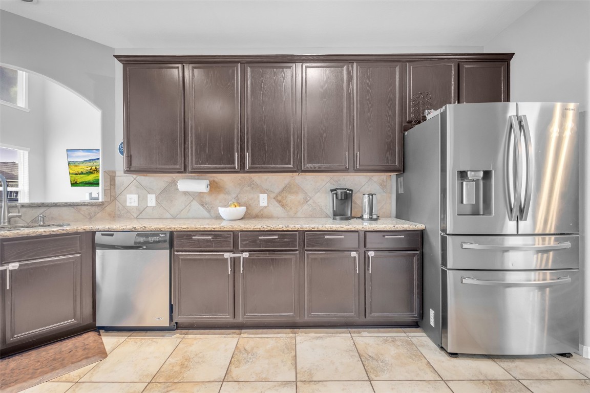 1230 Maple Ace Drive Katy, TX 77493 - Photo 13 of 40 a kitchen with stainless steel appliances granite countertop a refrigerator and a sink