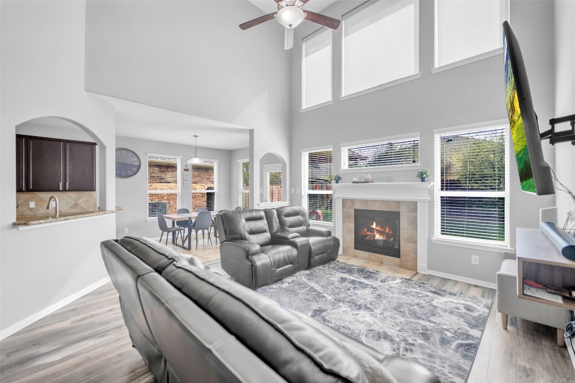 1230 Maple Ace Drive Katy, TX 77493 - Photo 18 of 40 a living room with furniture a fireplace and a flat screen tv