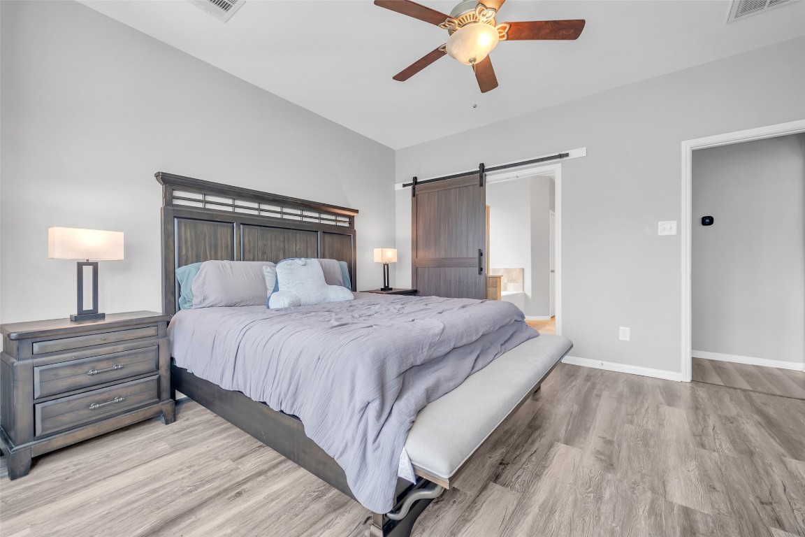 1230 Maple Ace Drive Katy, TX 77493 - Photo 24 of 40 a bedroom with a bed and a chandelier