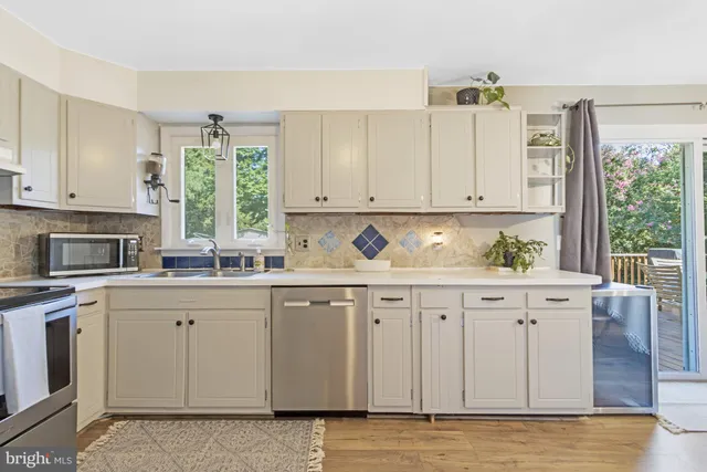a kitchen with granite countertop white cabinets and sink