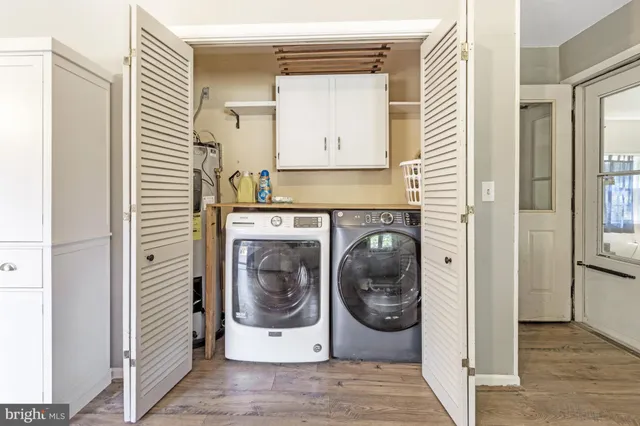 a utility room with sink dryer and washer