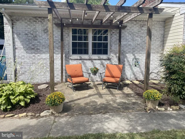 a view of a backyard with table and chairs
