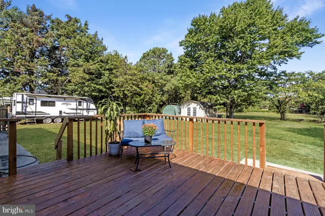 a view of outdoor space with deck and yard