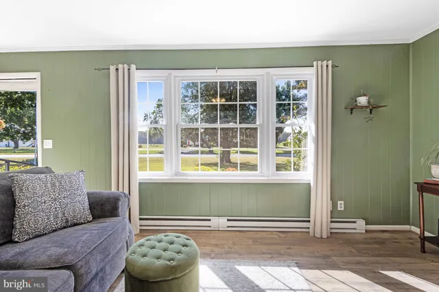 a living room with furniture and large window