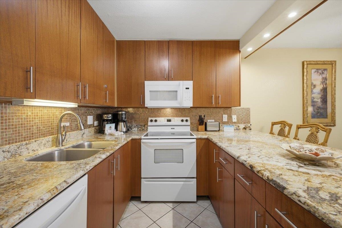 2695 South Kihei Road, Unit 5114 Kihei, HI 96753 - Photo 11 of 47 a kitchen with a sink stove and cabinets