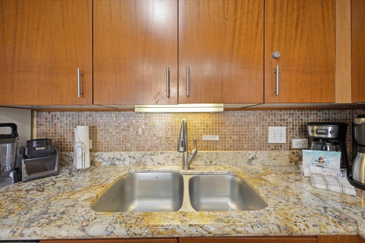 2695 South Kihei Road, Unit 5114 Kihei, HI 96753 - Photo 14 of 47 a kitchen with kitchen island granite countertop a sink window and cabinets