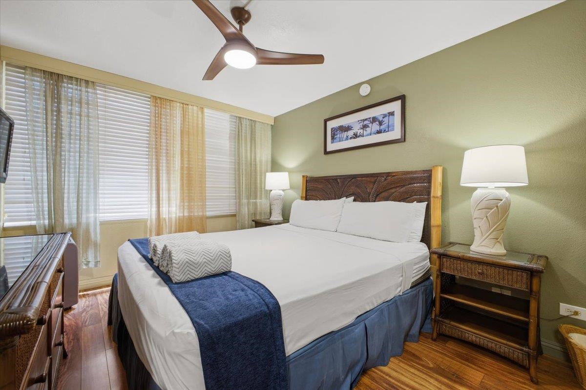2695 South Kihei Road, Unit 5114 Kihei, HI 96753 - Photo 15 of 47 a bedroom with a bed and wooden floor