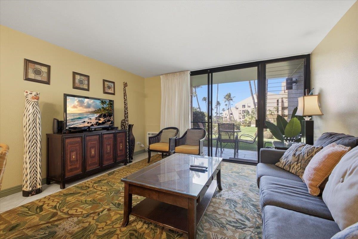 2695 South Kihei Road, Unit 5114 Kihei, HI 96753 - Photo 2 of 47 a living room with furniture and a flat screen tv