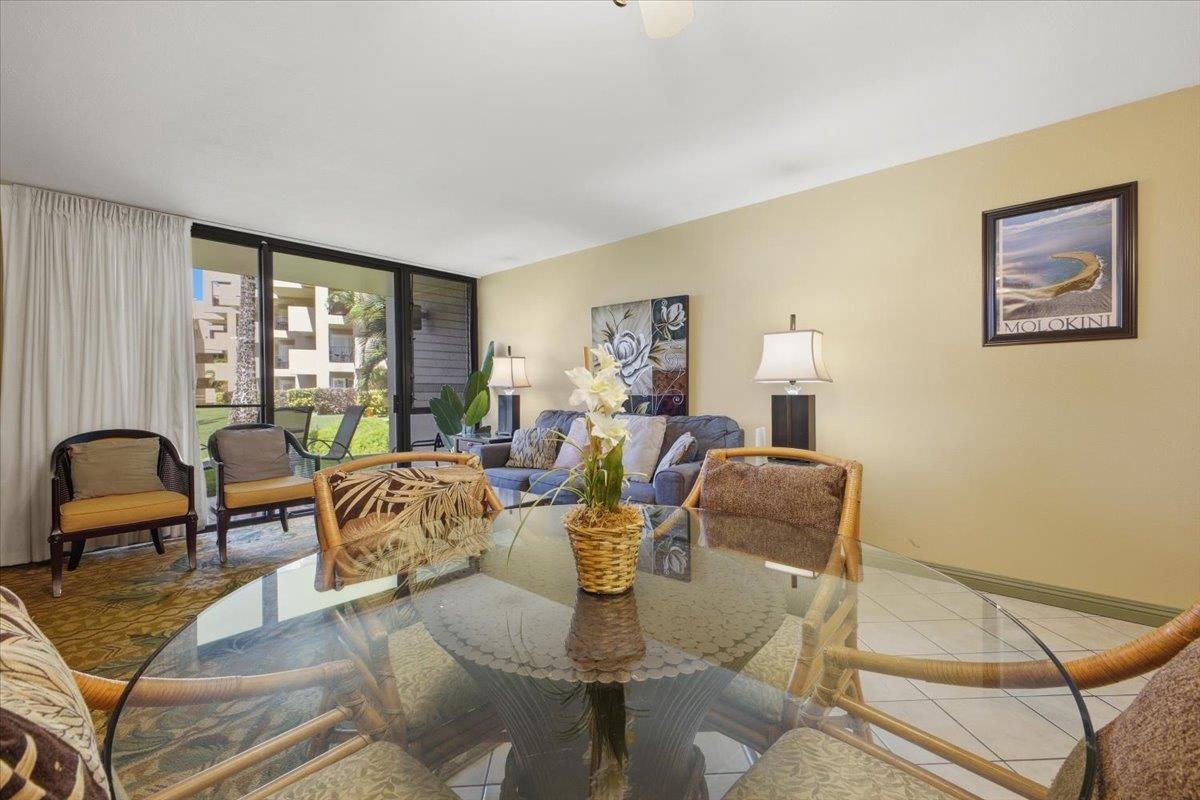 2695 South Kihei Road, Unit 5114 Kihei, HI 96753 - Photo 7 of 47 a living room with furniture two large windows and a dining table