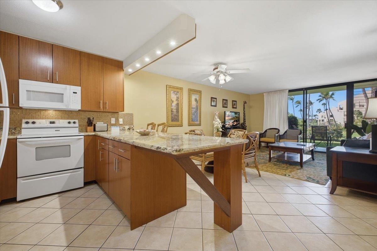 2695 South Kihei Road, Unit 5114 Kihei, HI 96753 - Photo 9 of 47 a kitchen with cabinets and chairs