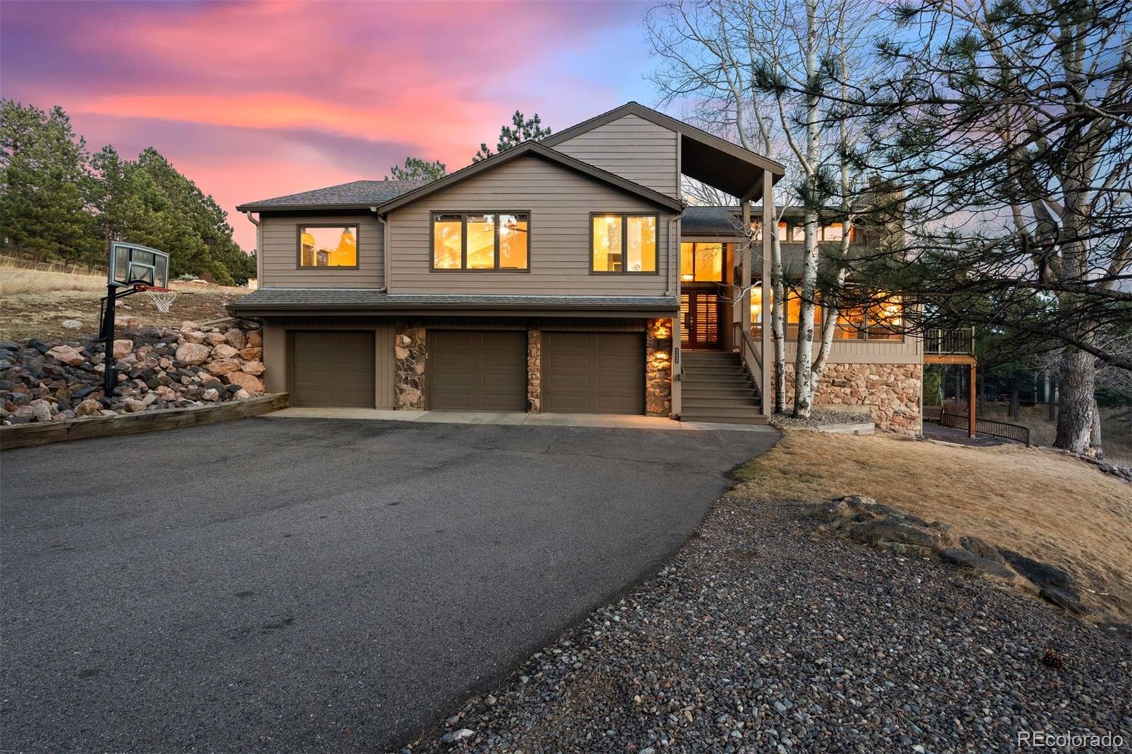 32430 Inverness Drive Evergreen, CO 80439 - Photo 1 of 50 a front view of a house with a garden