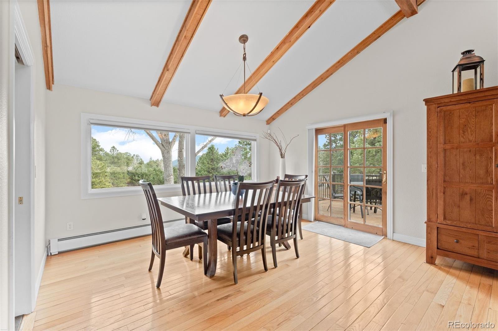 32430 Inverness Drive Evergreen, CO 80439 - Photo 13 of 50 a view of a dining room with furniture window and wooden floor