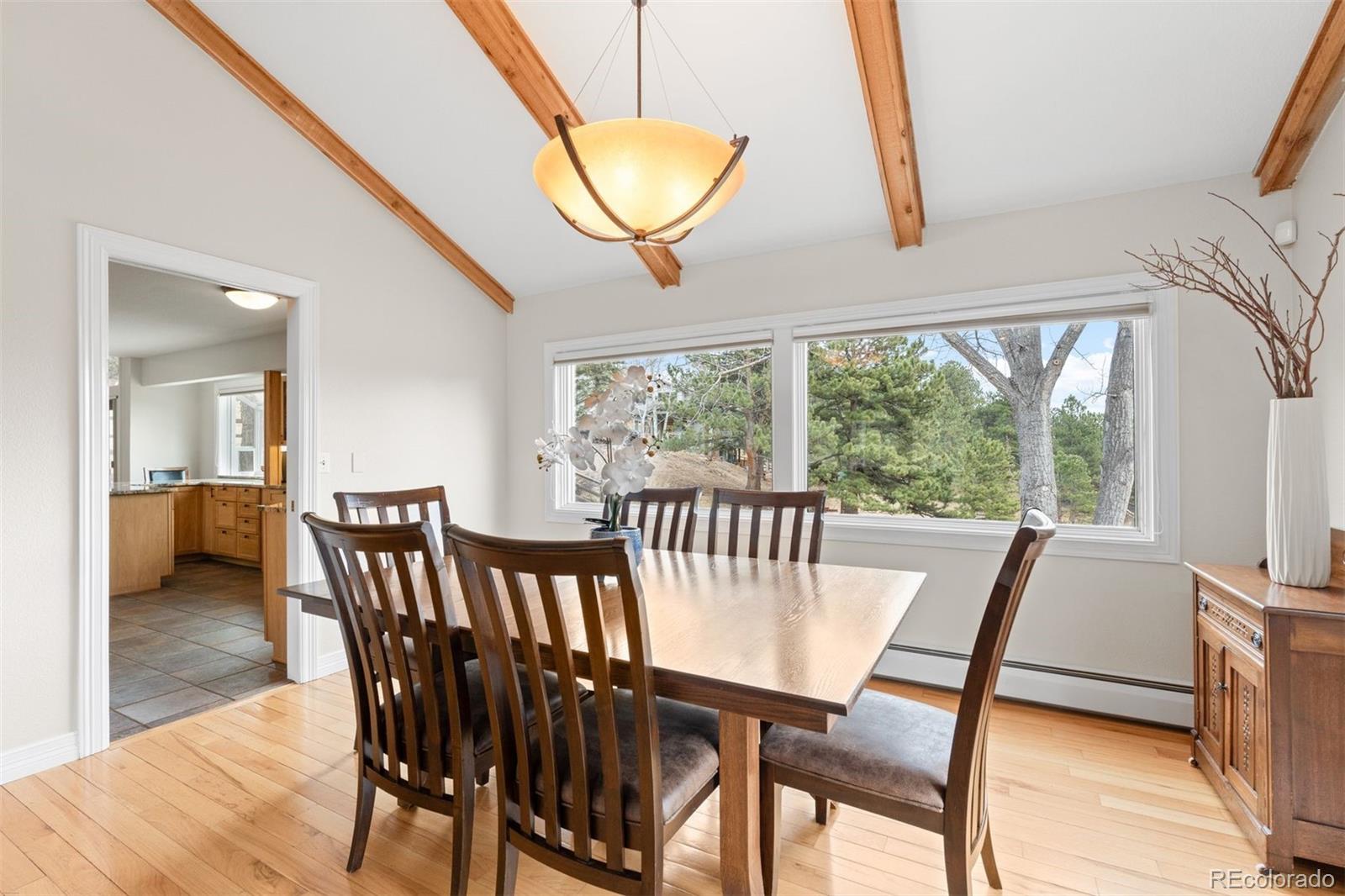 32430 Inverness Drive Evergreen, CO 80439 - Photo 14 of 50 a view of a dining room with furniture window and wooden floor