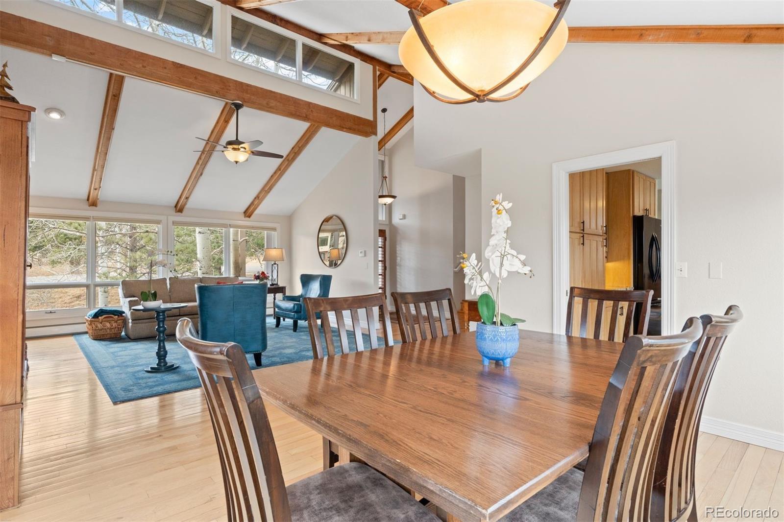 32430 Inverness Drive Evergreen, CO 80439 - Photo 15 of 50 a view of a dining room with furniture window and wooden floor