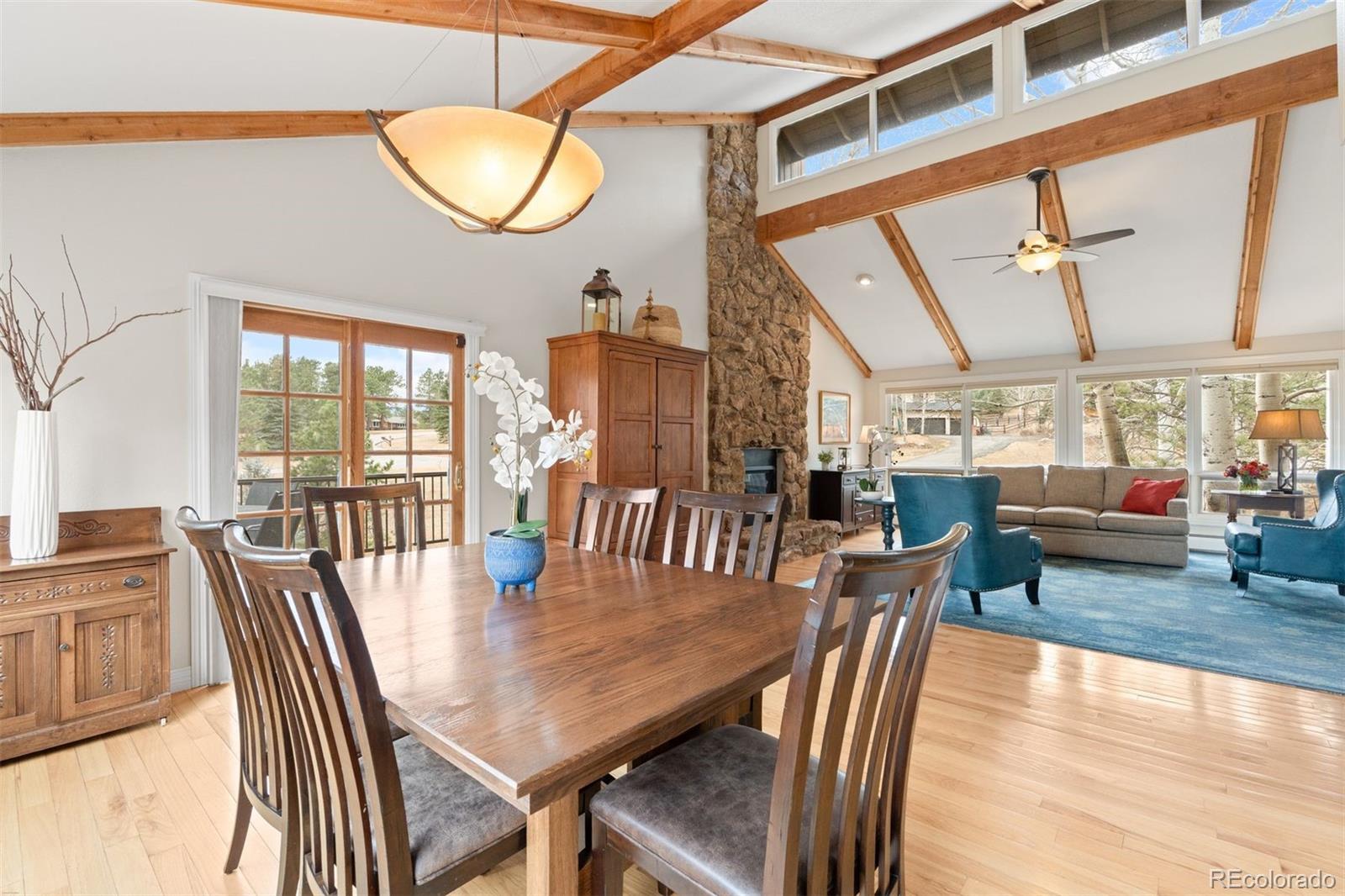 32430 Inverness Drive Evergreen, CO 80439 - Photo 16 of 50 a view of a dining room with furniture window and wooden floor