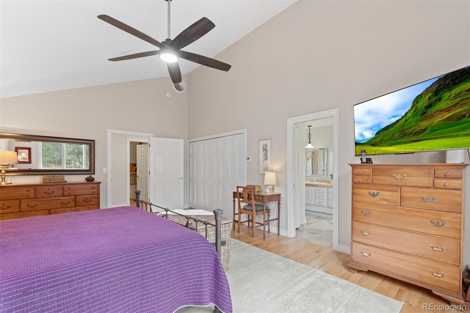 32430 Inverness Drive Evergreen, CO 80439 - Photo 19 of 50 a bedroom with a bed and furniture