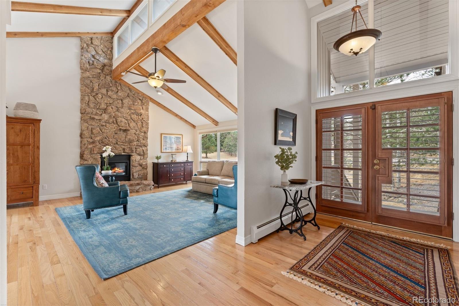 32430 Inverness Drive Evergreen, CO 80439 - Photo 2 of 50 a living room with furniture floor to ceiling window and hardwood floor