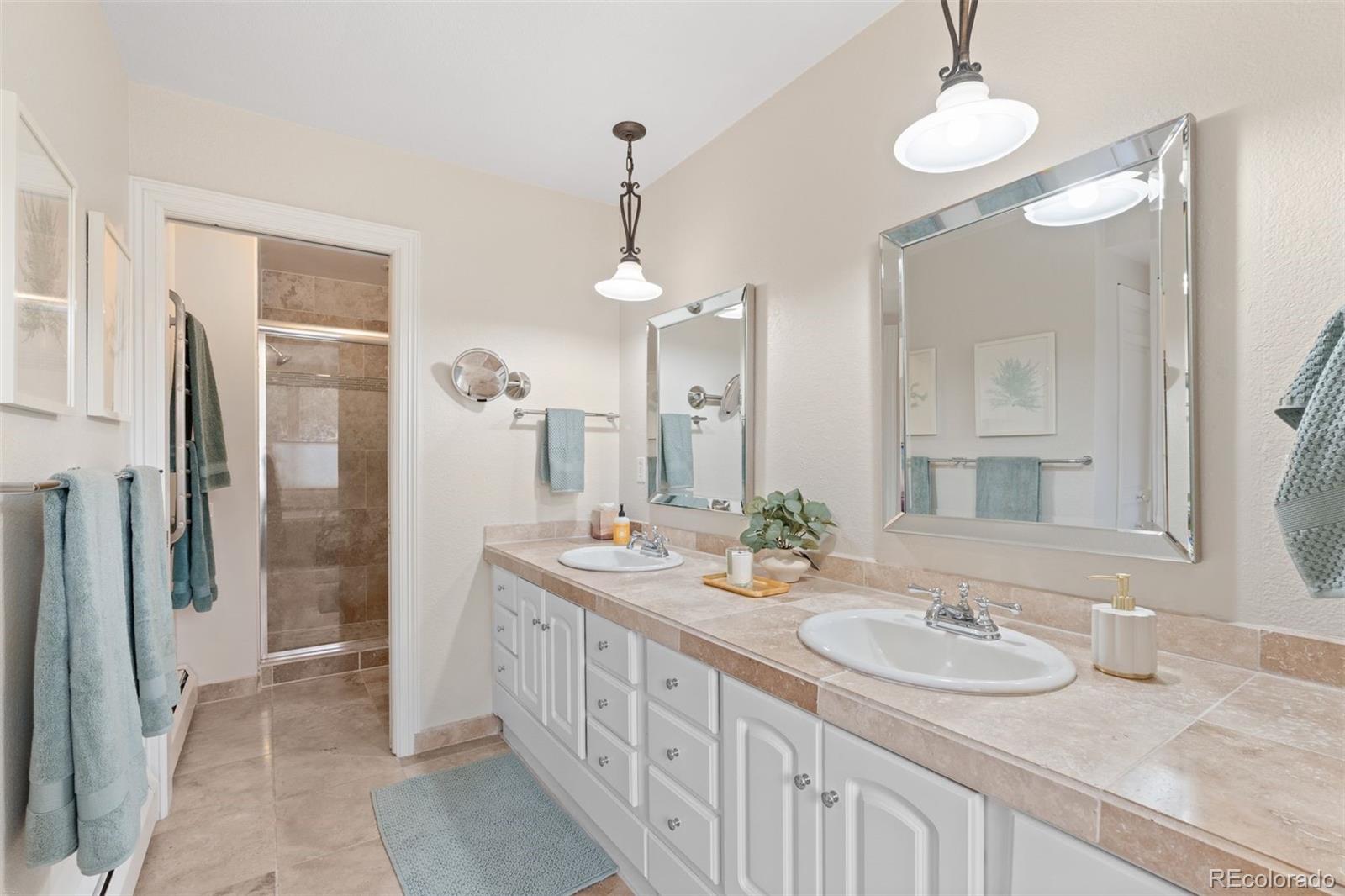 32430 Inverness Drive Evergreen, CO 80439 - Photo 22 of 50 a bathroom with double vanity sink and a mirror