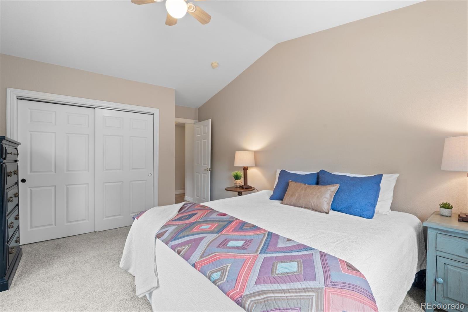 32430 Inverness Drive Evergreen, CO 80439 - Photo 25 of 50 a bedroom with a bed and a chandelier