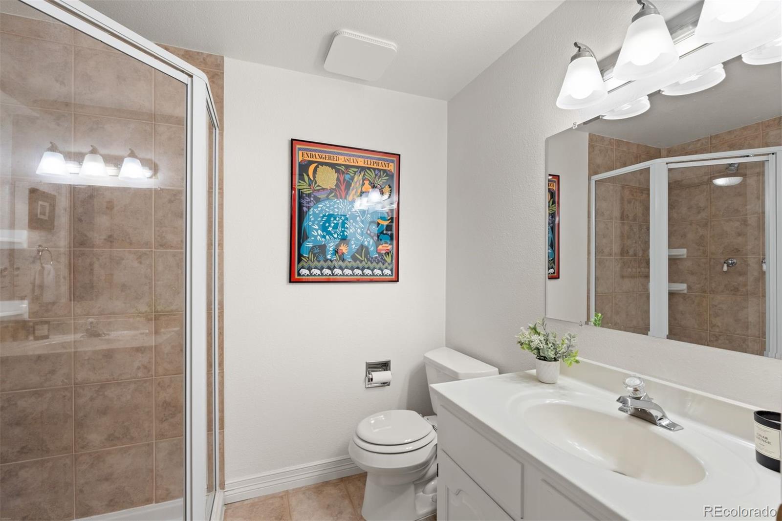 32430 Inverness Drive Evergreen, CO 80439 - Photo 32 of 50 a bathroom with a toilet a sink and mirror