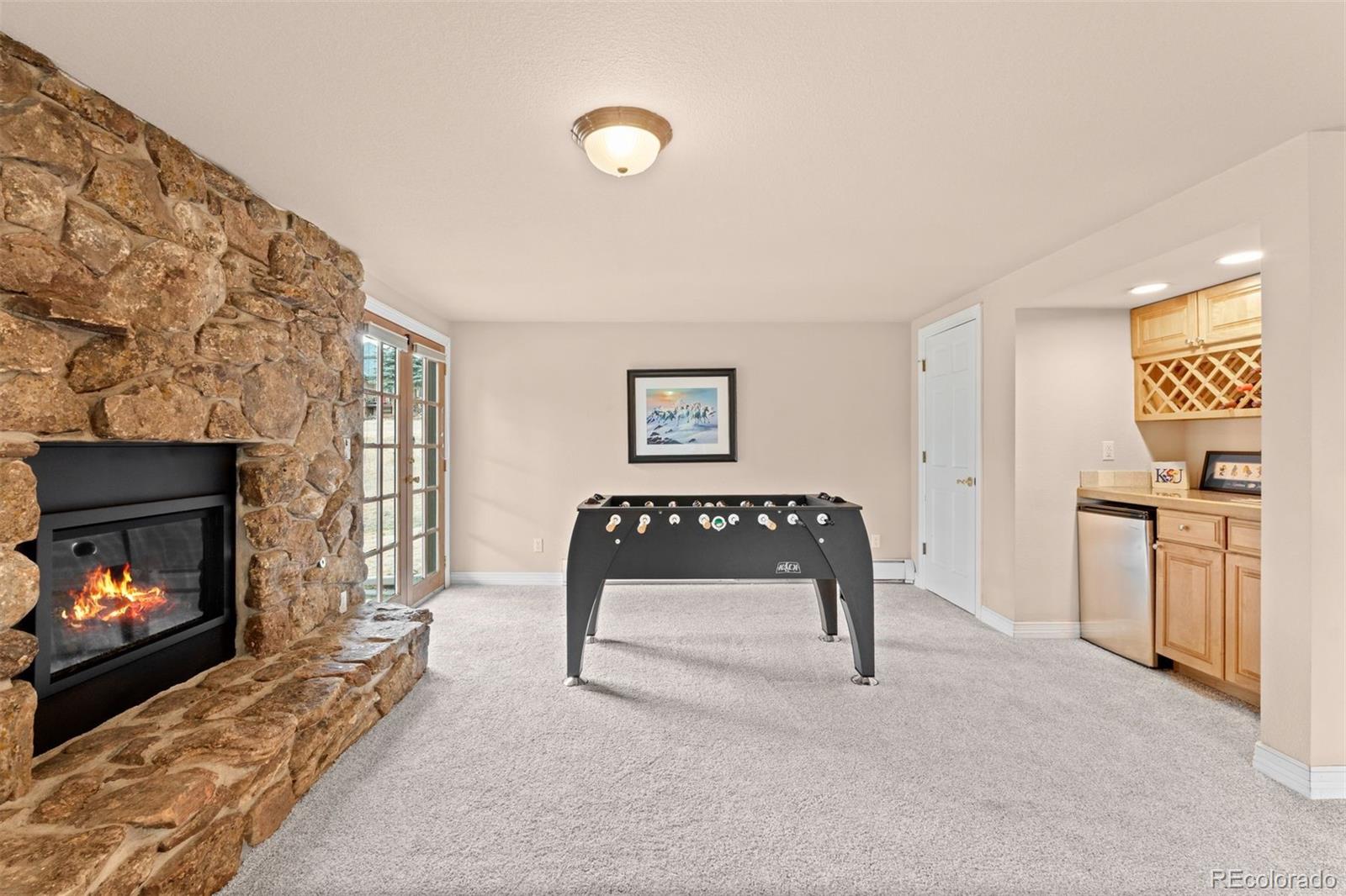 32430 Inverness Drive Evergreen, CO 80439 - Photo 34 of 50 a living room with furniture and a fireplace