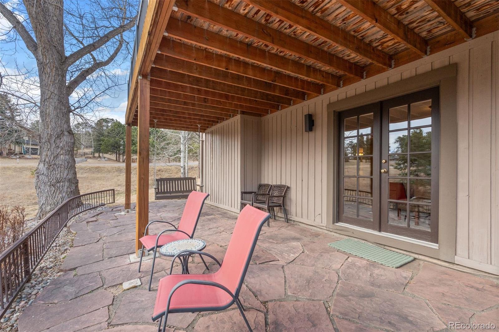 32430 Inverness Drive Evergreen, CO 80439 - Photo 38 of 50 a backyard of a house with outdoor seating