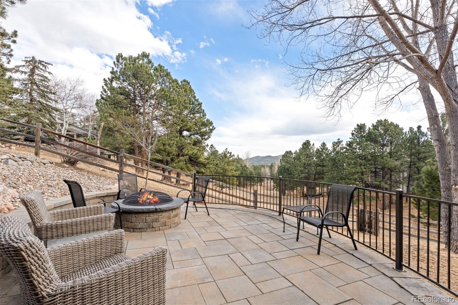 32430 Inverness Drive Evergreen, CO 80439 - Photo 39 of 50 a view of a terrace with couches and wooden fence