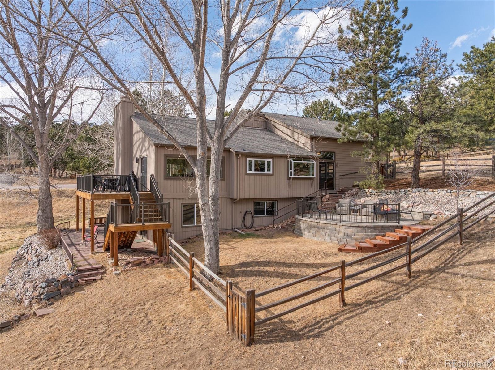 32430 Inverness Drive Evergreen, CO 80439 - Photo 40 of 50 a view of a house with backyard porch and sitting area