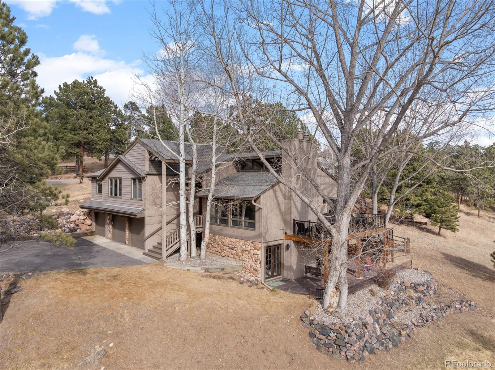 32430 Inverness Drive Evergreen, CO 80439 - Photo 45 of 50 front view of a house with a large tree