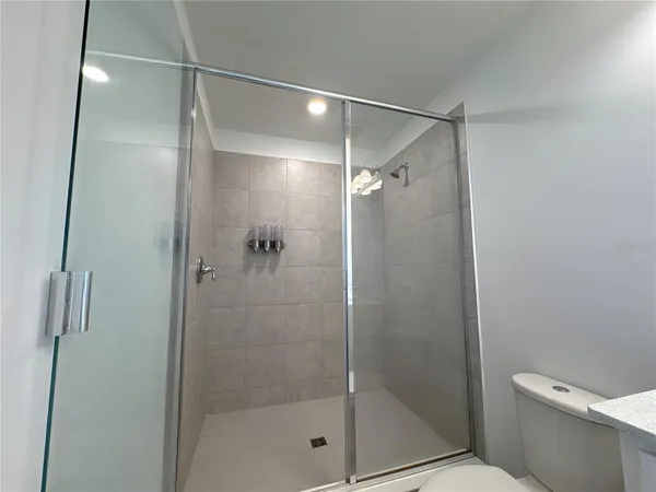 a bathroom that has a glass shower door