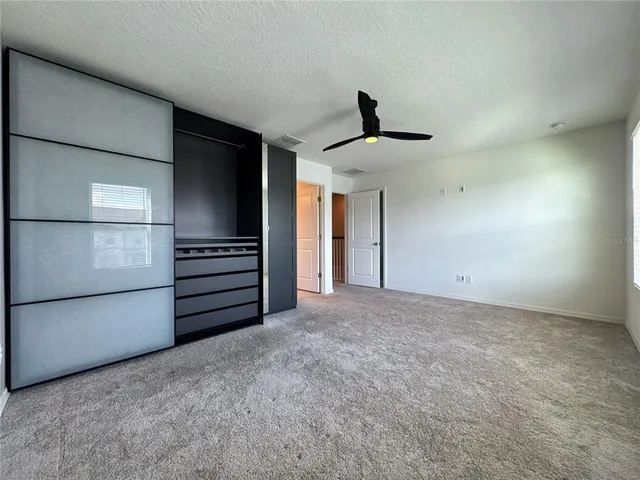 a view of an empty room with a kitchen
