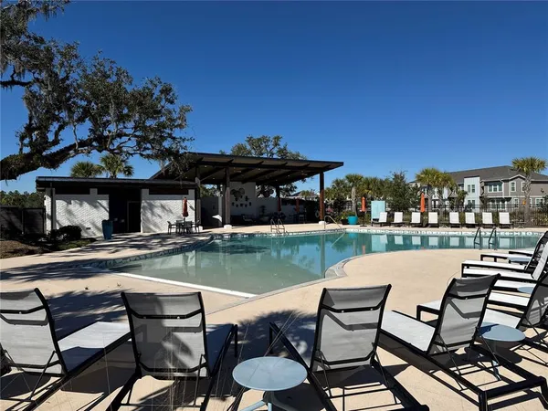 a view of a backyard with sitting area