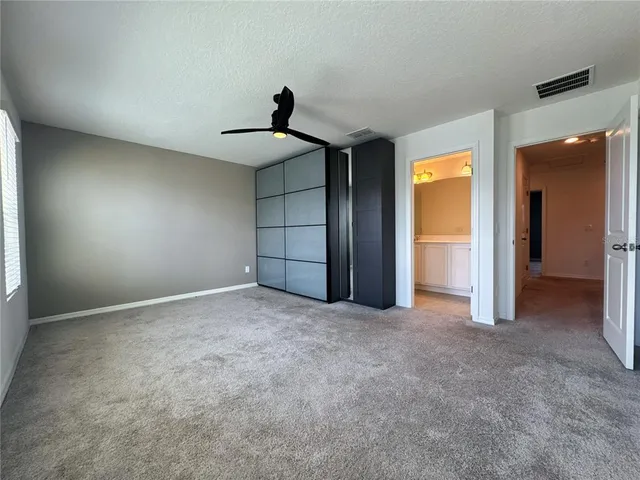 an empty room with a empty space and windows