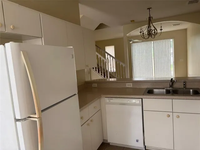 a kitchen with refrigerator and window