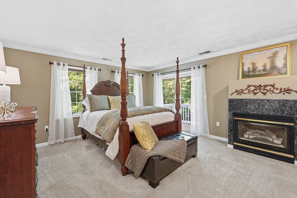 25 Haymeadow Road Boxford, MA 01921 - Photo 22 of 42 a bed room with a bed and a fireplace