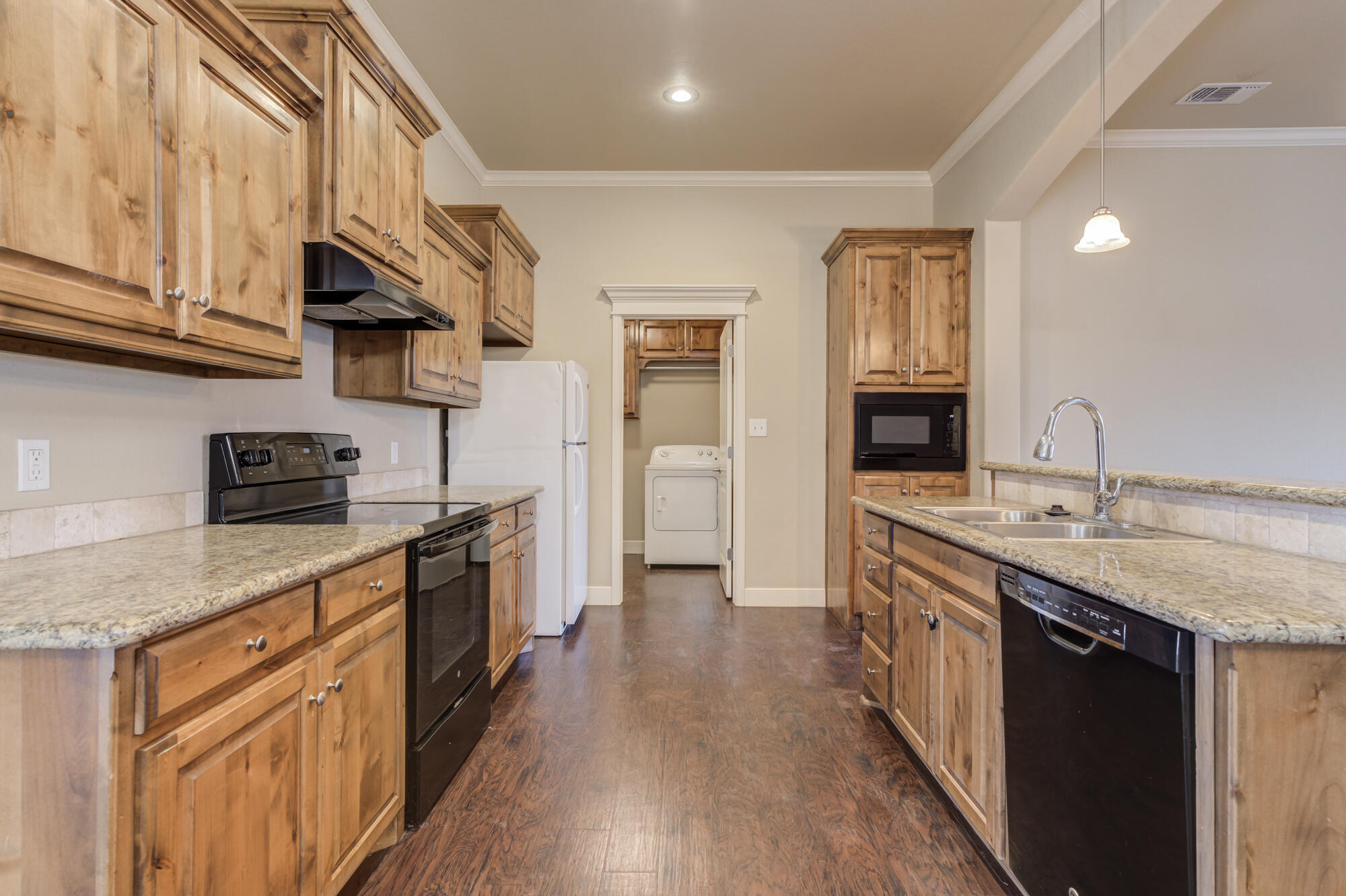 5220 Marshall Street Lubbock, TX 79416 - Photo 3 of 14 a kitchen with stainless steel appliances granite countertop a sink and stove