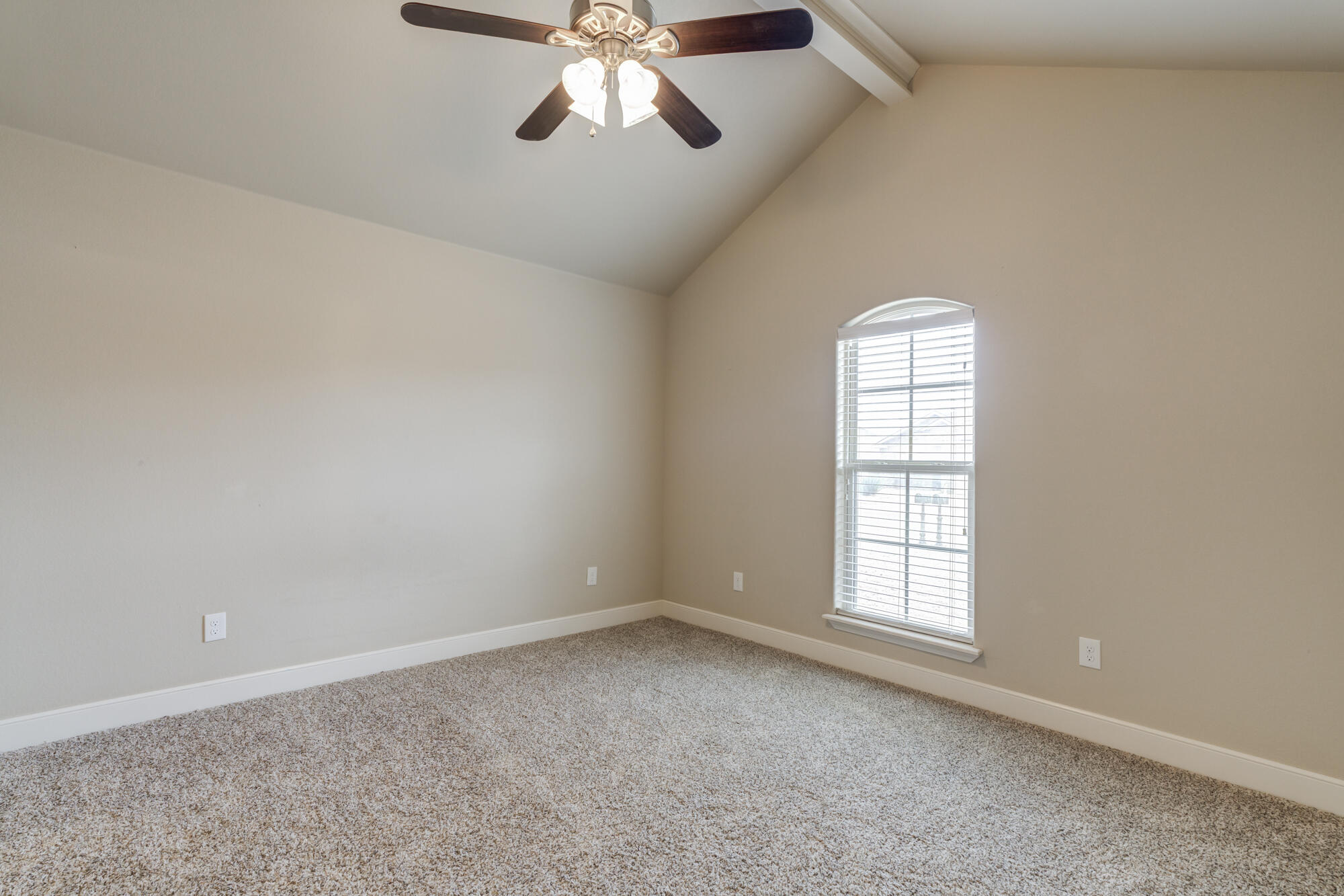 5220 Marshall Street Lubbock, TX 79416 - Photo 6 of 14 an empty room with windows and fan