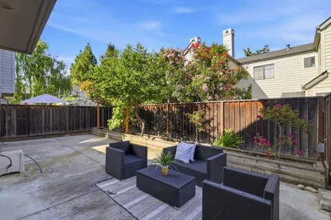 a view of a backyard with sitting area