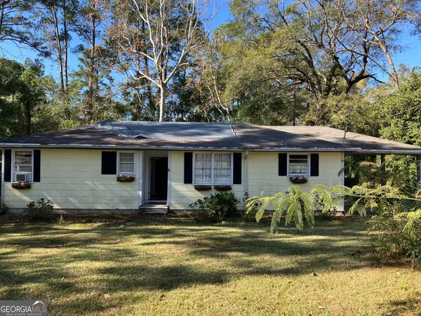 a view of a house with pool and sitting area